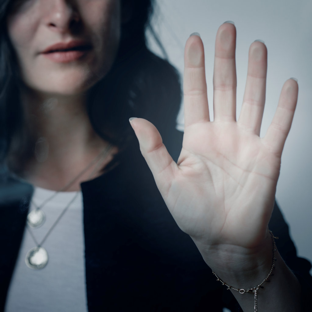 Woman with a beautiful hand touching the window